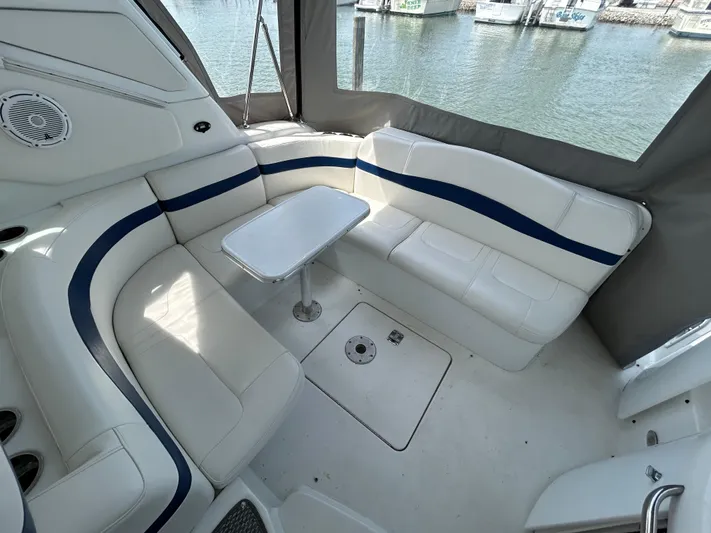  Yacht Photos Pics 2005 Formula 37 PC yacht interior with white seating and table, docked by the water.