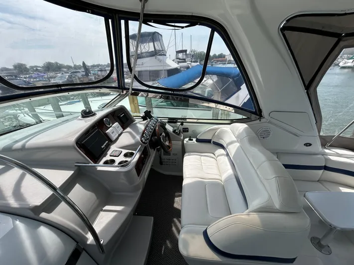  Yacht Photos Pics Interior of a 2005 Formula 37 PC yacht with white seating and control panel.