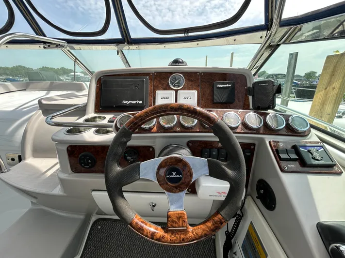  Yacht Photos Pics 2005 Formula 37 PC yacht dashboard with steering wheel and navigation instruments.
