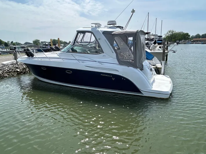  Yacht Photos Pics 2005 Formula 37 PC boat docked in a marina, side view.