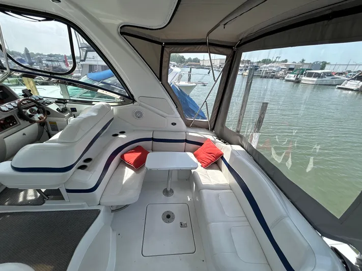  Yacht Photos Pics 2005 Formula 37 PC yacht interior with white seating, red cushions, and marina view.