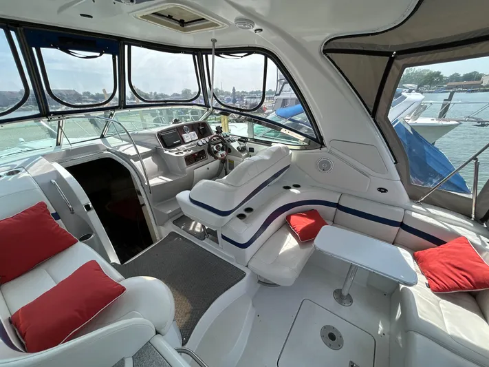  Yacht Photos Pics Interior of a 2005 Formula 37 PC yacht with white seating and red cushions.