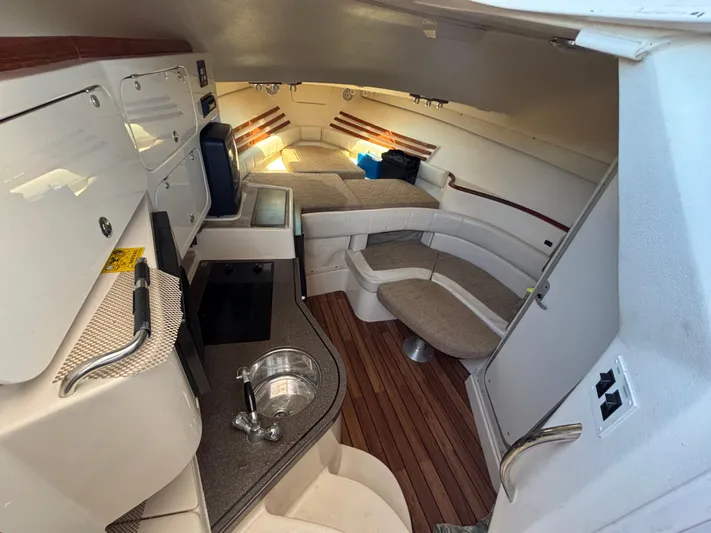 Kahuna Yacht Photos Pics 2002 Grady-White Express 330 cabin interior with kitchenette and seating area.