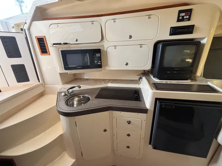 Kahuna Yacht Photos Pics 2002 Grady-White Express 330 boat interior with kitchenette, microwave, and TV.