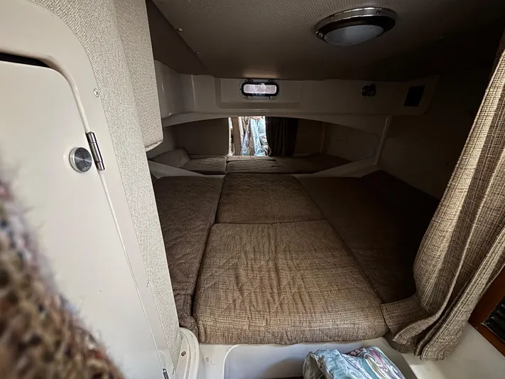 Kahuna Yacht Photos Pics 2002 Grady-White Express 330 cabin interior with cozy sleeping area and beige upholstery.