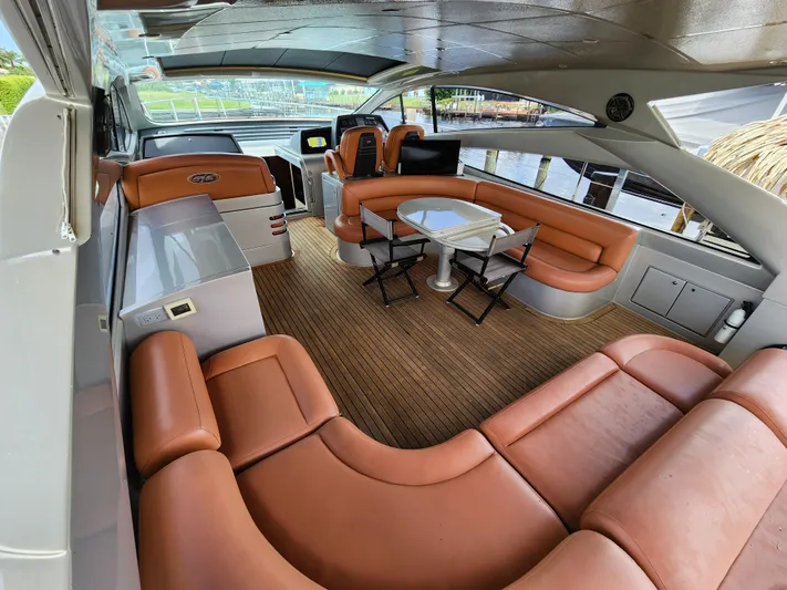 Rx 1 Yacht Photos Pics Luxurious interior of a 2006 Pershing Cruiser with leather seating and wooden flooring.