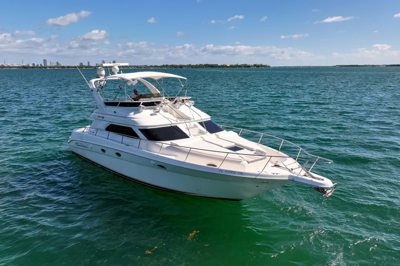 Pal'party Yacht Photos Pics 2000 Sea Ray 450 Express Bridge yacht cruising on clear blue waters.