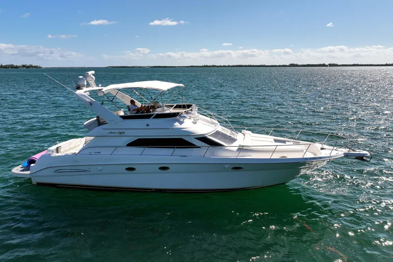 Pal'party Yacht Photos Pics 2000 Sea Ray 450 Express Bridge yacht cruising on open water under clear skies.