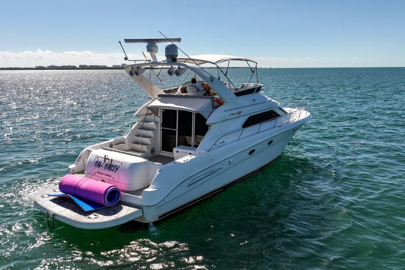 Pal'party Yacht Photos Pics 2000 Sea Ray 450 Express Bridge yacht on open water, sunny day, rear view.