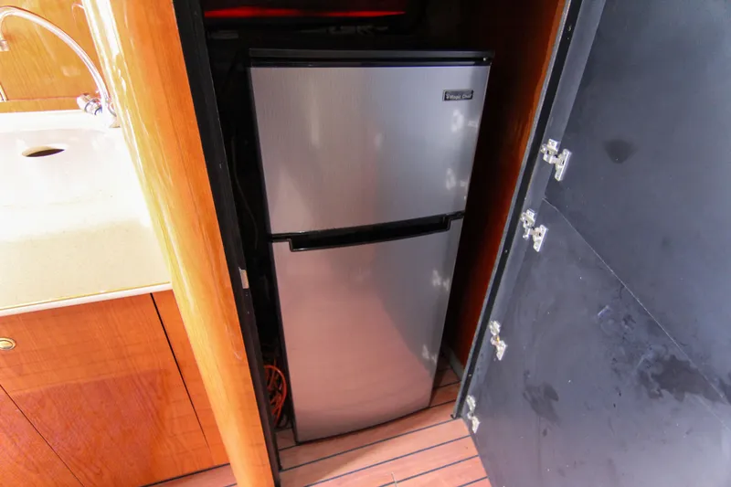 Pal'party Yacht Photos Pics Stainless steel fridge in 2000 Sea Ray 450 Express Bridge yacht kitchen.
