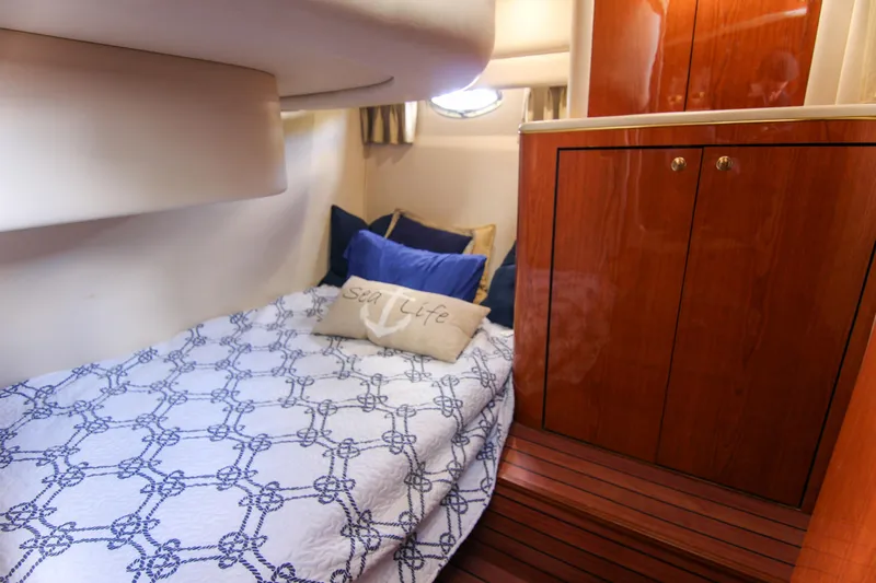 Pal'party Yacht Photos Pics Cozy cabin interior of 2000 Sea Ray 450 Express Bridge with nautical bedding.
