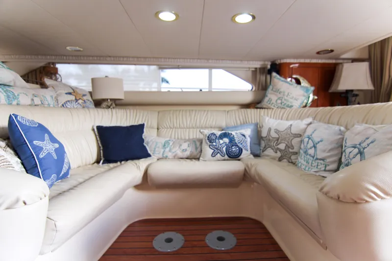 Pal'party Yacht Photos Pics Luxurious interior of 2000 Sea Ray 450 Express Bridge with nautical-themed cushions.