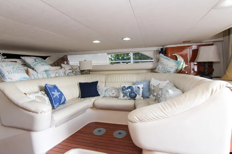 Pal'party Yacht Photos Pics Luxurious interior of 2000 Sea Ray 450 Express Bridge with plush seating and decorative pillows.