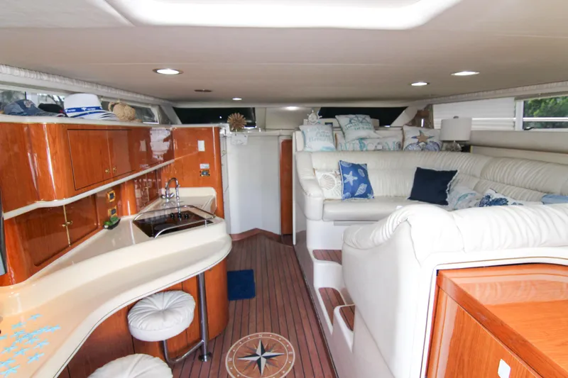 Pal'party Yacht Photos Pics Luxurious interior of 2000 Sea Ray 450 Express Bridge with elegant seating and wood finishes.