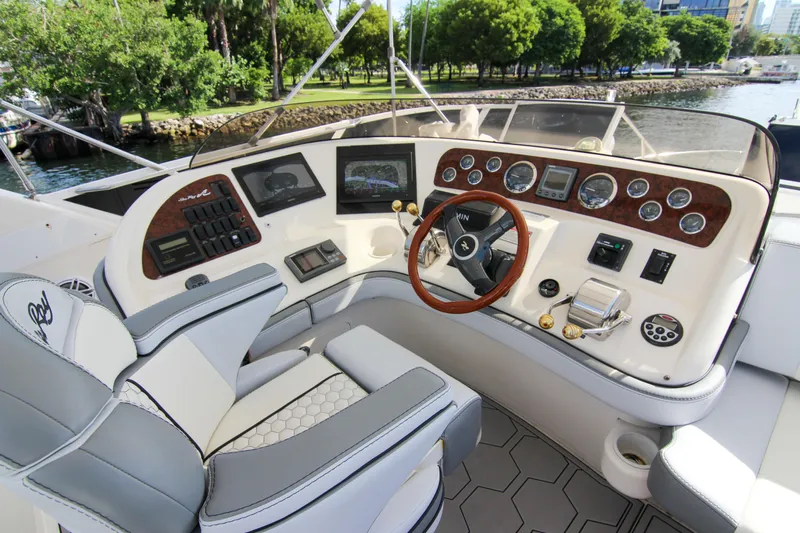 Pal'party Yacht Photos Pics 2000 Sea Ray 450 Express Bridge helm with modern controls and luxurious seating.