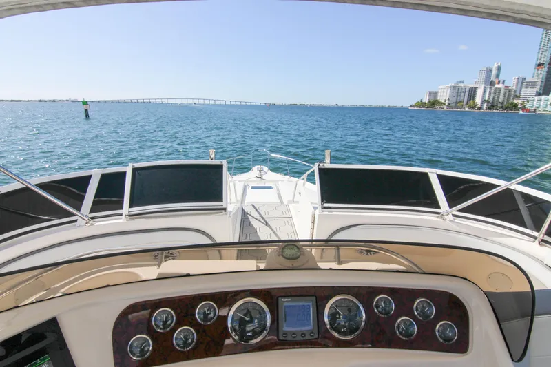 Pal'party Yacht Photos Pics Cockpit view from 2000 Sea Ray 450 Express Bridge, overlooking ocean and city skyline.