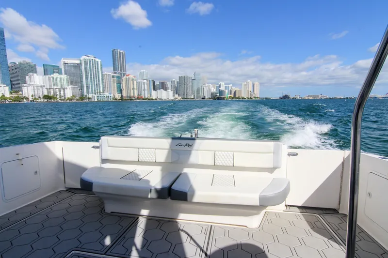 Pal'party Yacht Photos Pics Sea Ray 450 Express Bridge cruising with city skyline in the background, 2000 model.