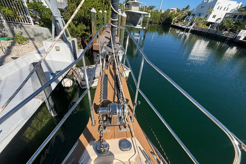 Inspiration Yacht Photos Pics Bow view of 1989 Island Packet 38 sailboat docked in a serene canal.