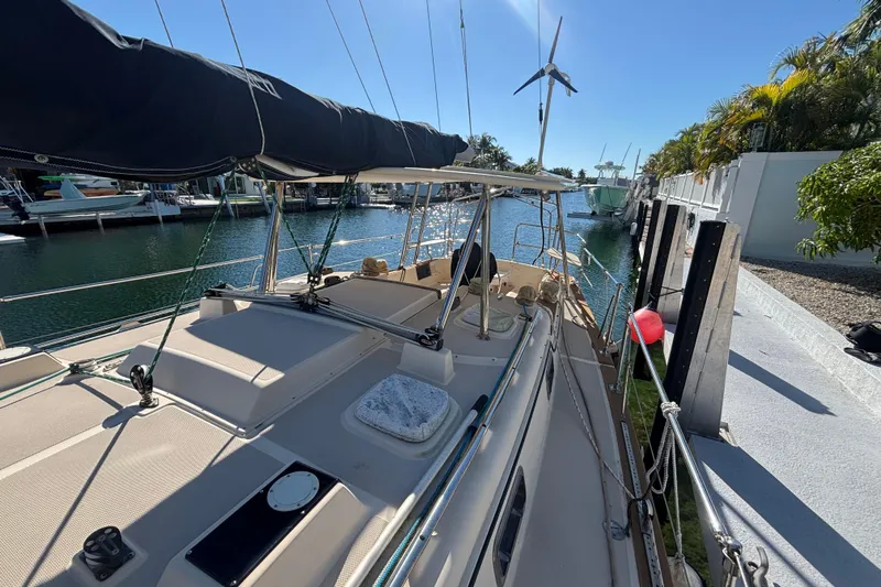 Inspiration Yacht Photos Pics 1989 Island Packet 38 sailboat docked in sunny marina with wind turbine.