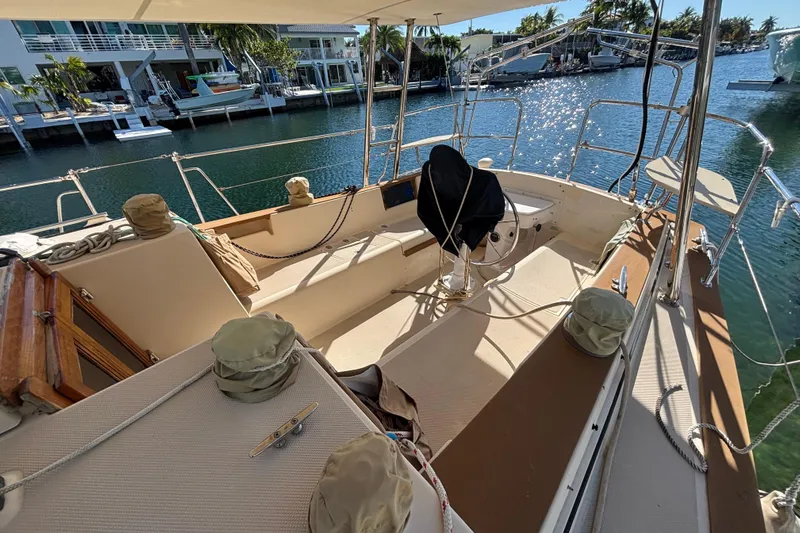 Inspiration Yacht Photos Pics 1989 Island Packet 38 sailboat cockpit with marina view, featuring covered equipment and seating.