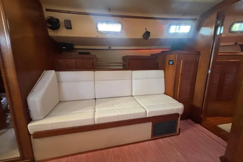 Inspiration Yacht Photos Pics Interior of 1989 Island Packet 38 sailboat with white cushioned seating.
