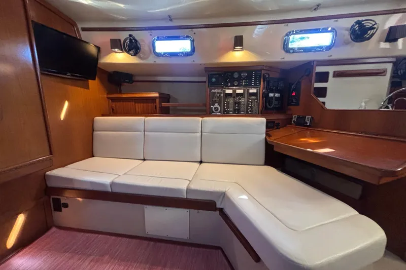 Inspiration Yacht Photos Pics Interior of 1989 Island Packet 38 sailboat with white seating and navigation station.