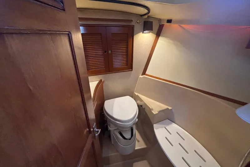 Inspiration Yacht Photos Pics 1989 Island Packet 38 yacht bathroom with wooden cabinets and compact toilet.