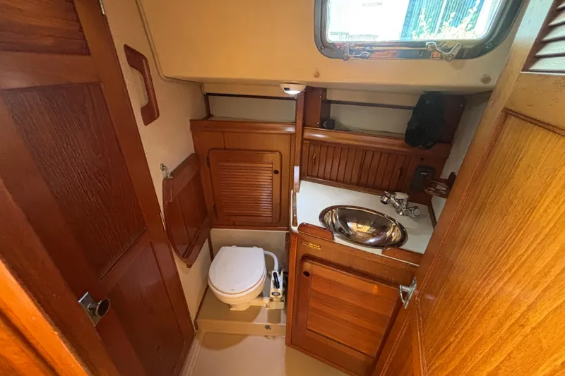Inspiration Yacht Photos Pics 1989 Island Packet 38 yacht bathroom with wooden cabinetry and stainless steel sink.