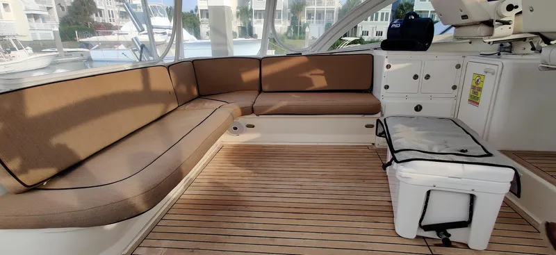 Short People Yacht Photos Pics Interior of 1999 Ocean Yachts EXPRESS with cushioned seating and wooden flooring.