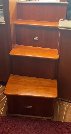 Short People Yacht Photos Pics Wooden stairs inside 1999 Ocean Yachts EXPRESS boat, featuring polished finish and compact design.