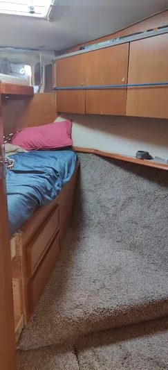 Short People Yacht Photos Pics Cozy cabin interior of 1999 Ocean Yachts EXPRESS with bed and wooden storage.