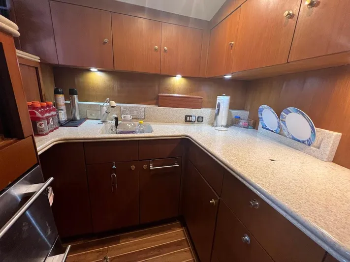 Short People Yacht Photos Pics 1999 Ocean Yachts EXPRESS kitchen with wooden cabinets and modern appliances.