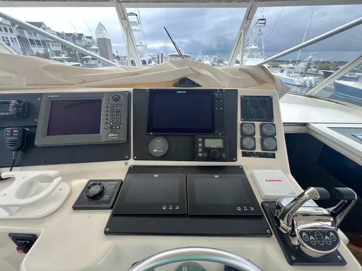 Short People Yacht Photos Pics 1999 Ocean Yachts EXPRESS helm with navigation equipment and controls, docked at marina.