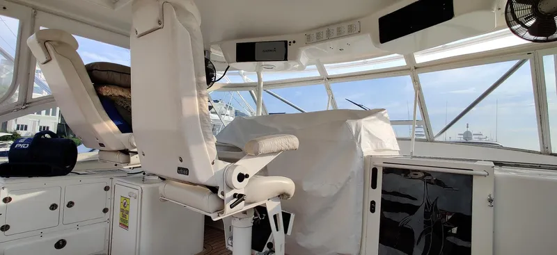 Short People Yacht Photos Pics Interior of 1999 Ocean Yachts EXPRESS boat with white seating and control panel.