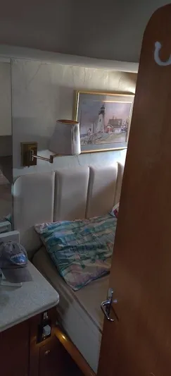 Short People Yacht Photos Pics Cozy cabin interior of 1999 Ocean Yachts EXPRESS with bed and nautical decor.