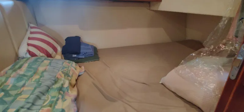 Short People Yacht Photos Pics Cozy cabin interior of 1999 Ocean Yachts EXPRESS with bedding and pillows.