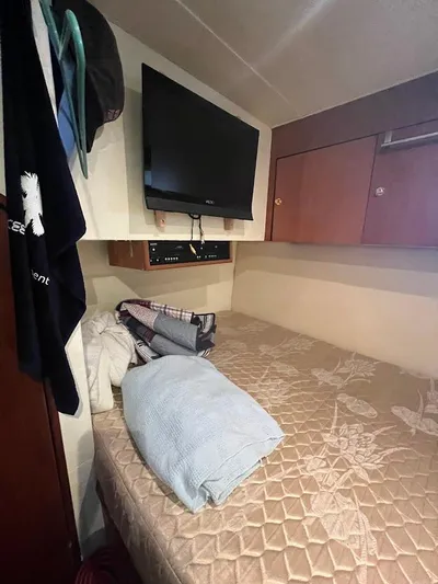 Short People Yacht Photos Pics Cozy cabin interior of 1999 Ocean Yachts EXPRESS with TV and bedding.
