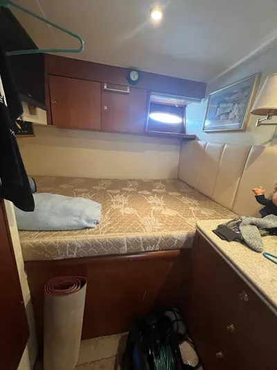 Short People Yacht Photos Pics Cozy cabin interior of 1999 Ocean Yachts EXPRESS with bed and storage.