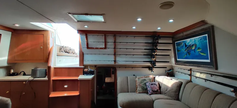 Short People Yacht Photos Pics Interior of 1999 Ocean Yachts EXPRESS with cozy seating and fishing rod storage.
