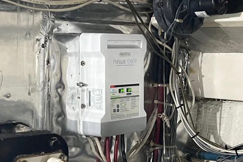 Short People Yacht Photos Pics Electrical system inside a 1999 Ocean Yachts Sport Fish boat, featuring ProNautic charger.