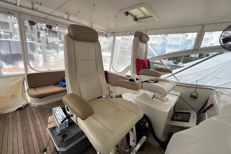 Short People Yacht Photos Pics 1999 Ocean Yachts Sport Fish interior with helm chairs and wooden flooring.