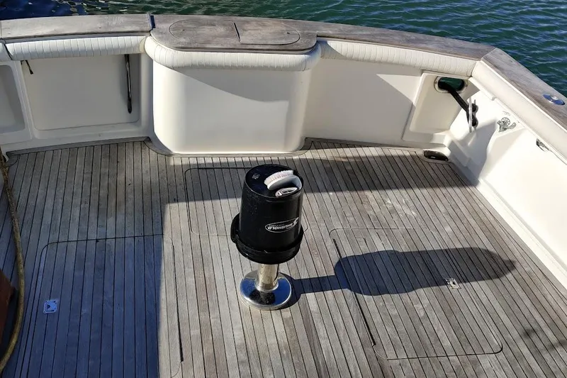 Short People Yacht Photos Pics 1999 Ocean Yachts Sport Fish deck with wooden flooring and fishing equipment.