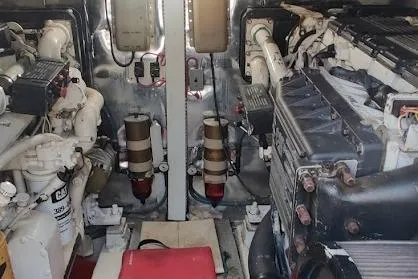 Short People Yacht Photos Pics Engine room of a 1999 Ocean Yachts Sport Fish boat, showcasing mechanical components.