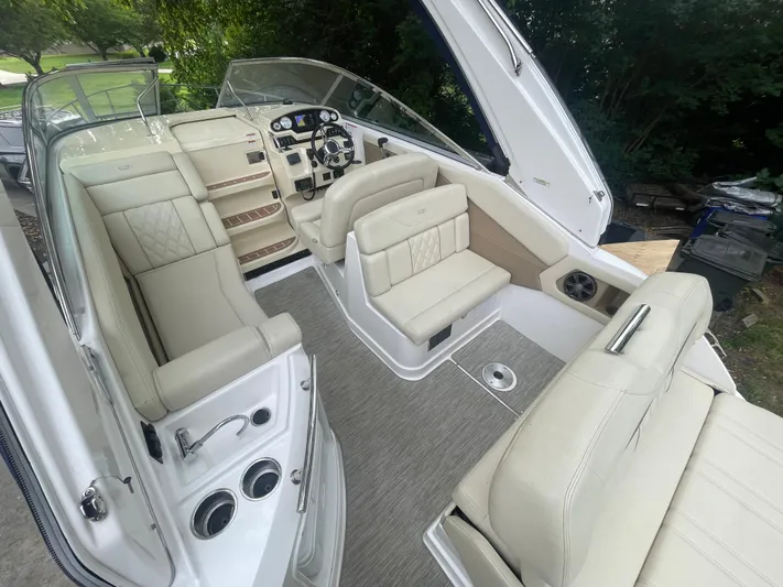  Yacht Photos Pics 2019 Regal 28 Express boat interior with beige seating and modern dashboard.