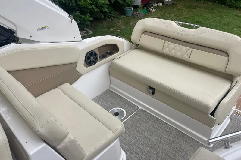  Yacht Photos Pics 2019 Regal 28 Express boat interior with beige seating and speaker system.