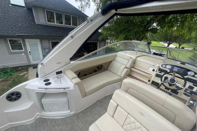  Yacht Photos Pics 2019 Regal 28 Express boat interior with beige seating and modern dashboard.