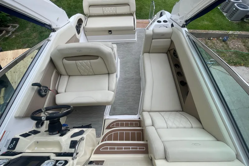  Yacht Photos Pics 2019 Regal 28 Express boat interior with beige seating and steering wheel.