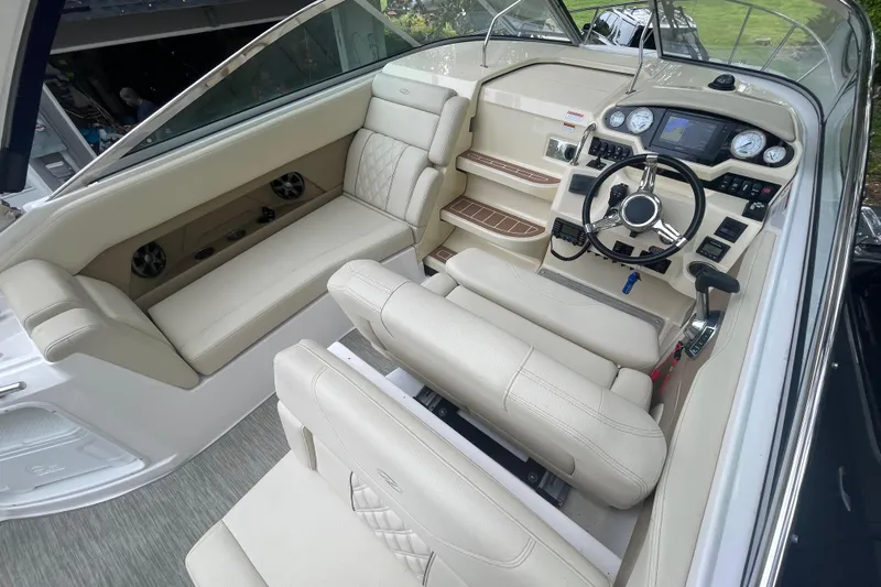  Yacht Photos Pics 2019 Regal 28 Express boat interior with beige seating and modern dashboard controls.