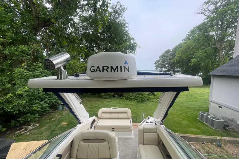  Yacht Photos Pics 2019 Regal 28 Express boat with Garmin radar, surrounded by lush greenery.