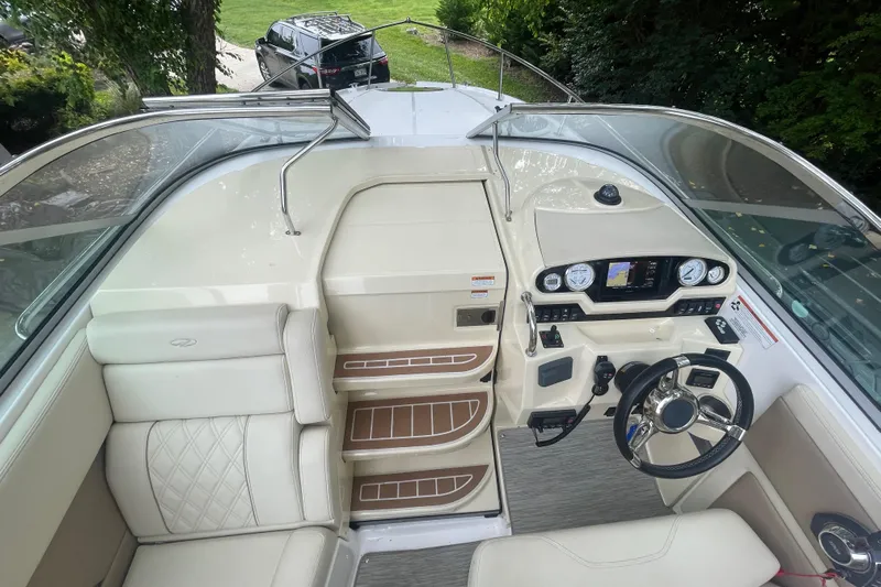  Yacht Photos Pics 2019 Regal 28 Express boat interior with steering wheel, dashboard, and seating.